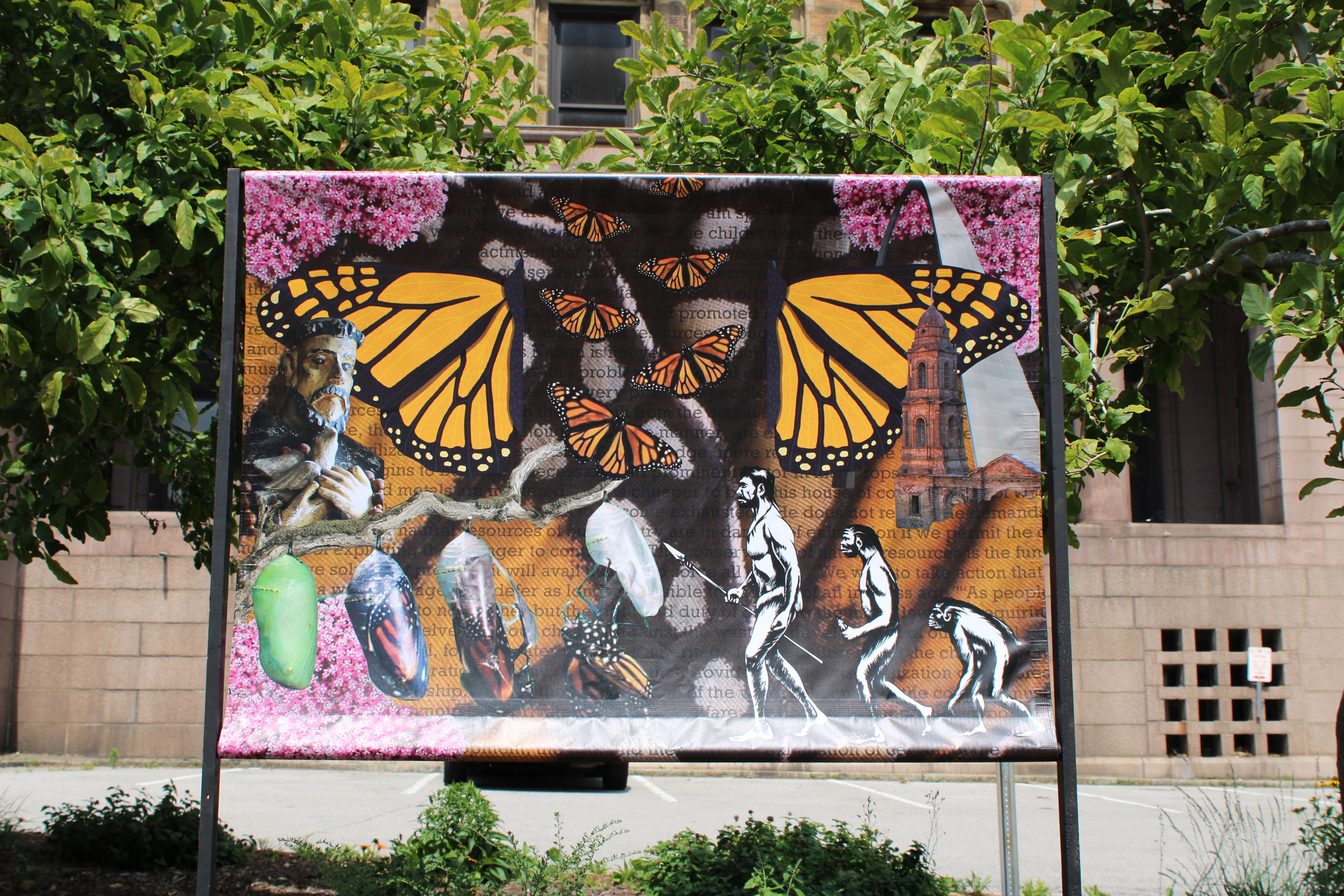 “Monarchs and Mankind” Mural featuring pictures of monarch butterfly wings, human evolution, butterfly metamorphosis, and various other icons.