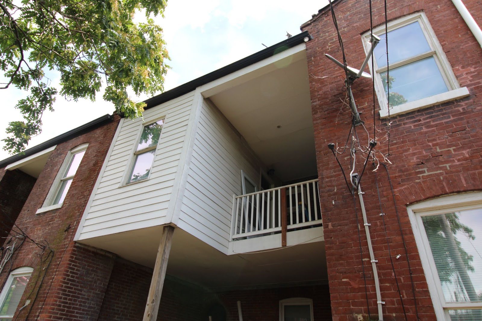 HHRP 1 Back view of Ms. Hudson’s home, currently undergoing weatherization and backyard repairs