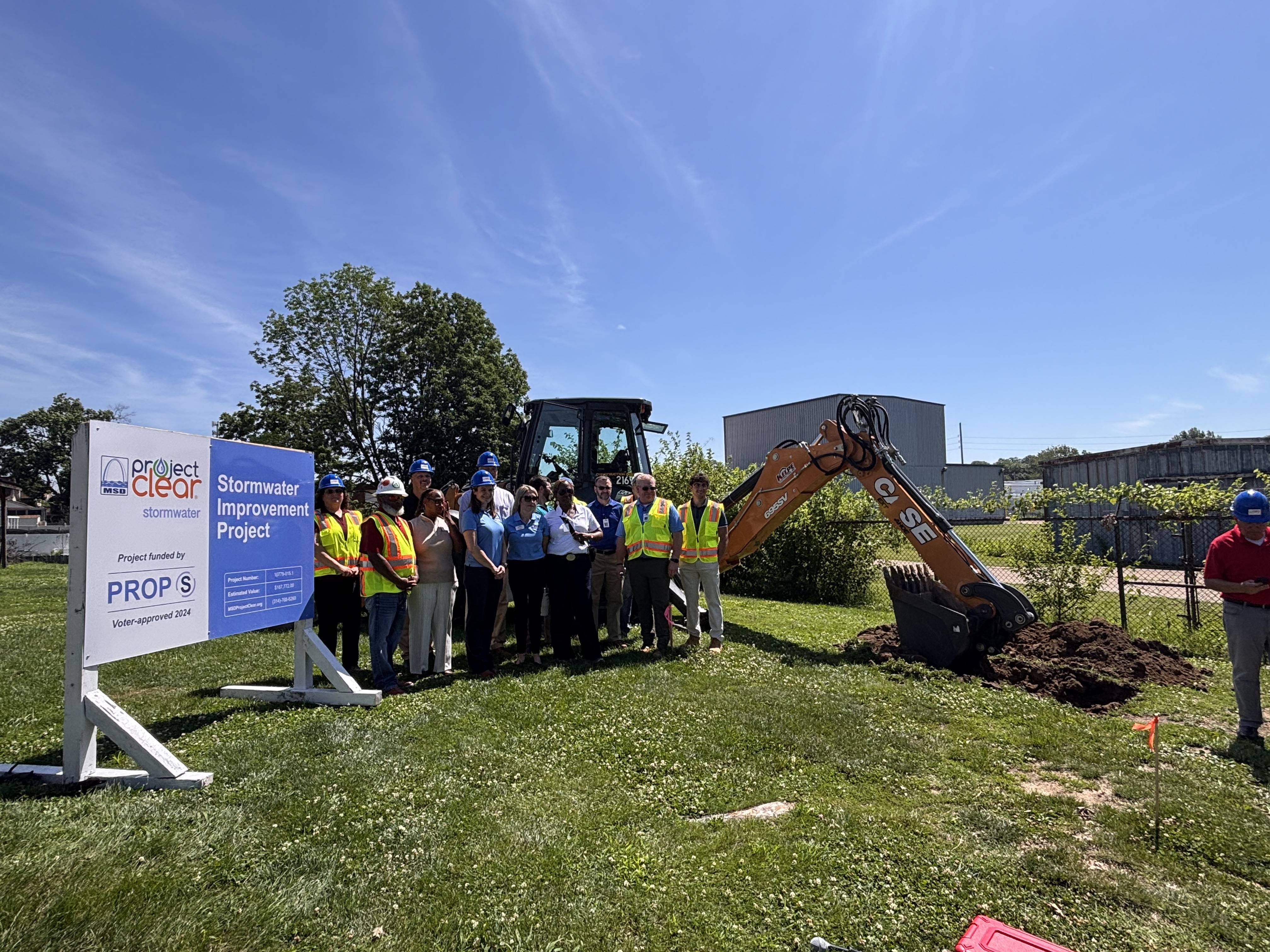 IMG_2174 (1) Metropolitan St. Louis Sewer District workers and city leaders in front of site with excavator.