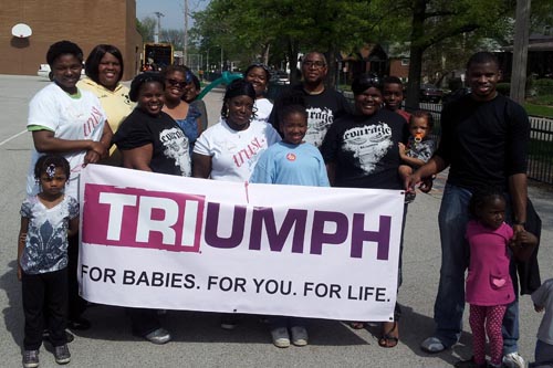 TRIUMPH Community Festival group shot with banner