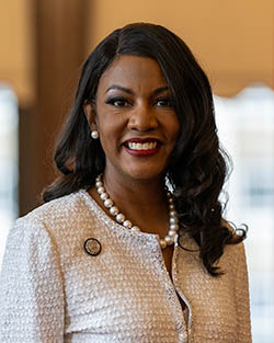 Mayor Tishaura Jones in a white suit in her office