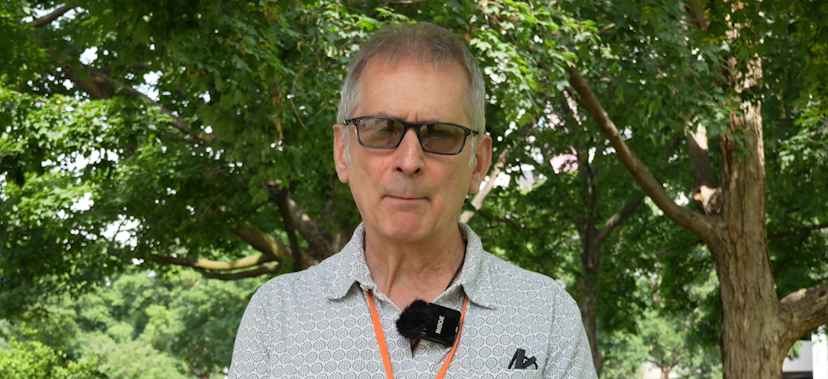 A gentleman wearing sunglasses looking into the camera