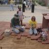 Neighborhood kids lend a hand with the pavers
