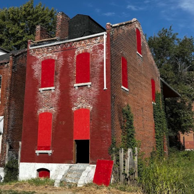 1421 Destrehan St a two-story brick building with boarded-up windows