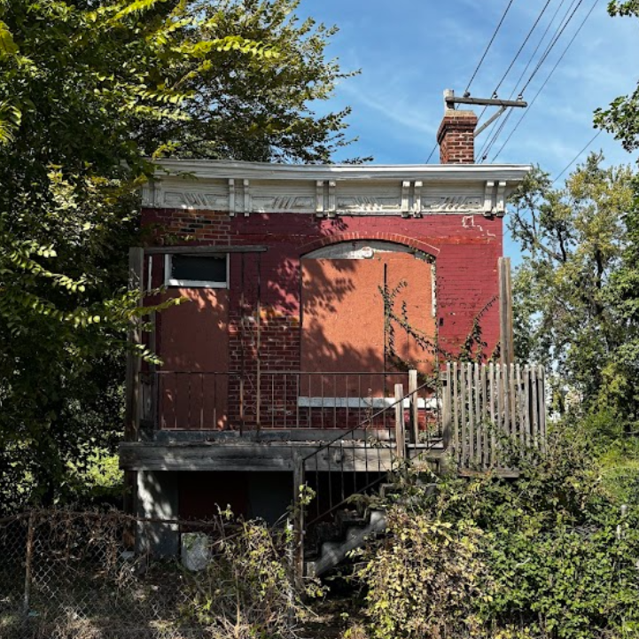 1713 Billups Ave a one-story brick building with boarded-up windows