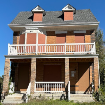 4631 Page Blvd a two-story brick building with boarded-up windows
