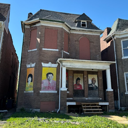 5114 Page Blvd a two-story brick building with boarded-up windows