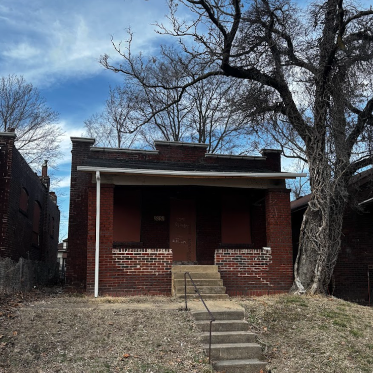 5251 Emerson Ave a one-story brick building with boarded-up windows