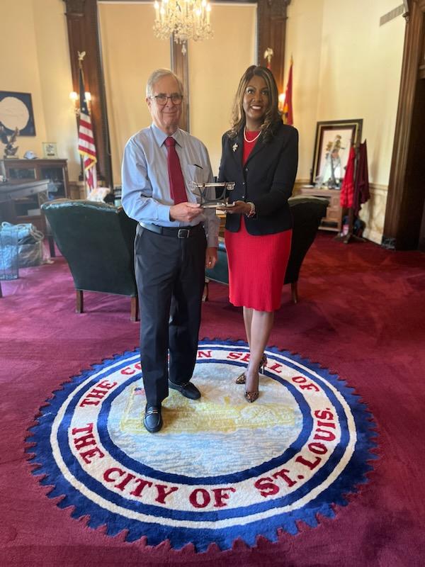 Dr. Michael Graham receives the key to the city from Mayor Tishaura O. Jones