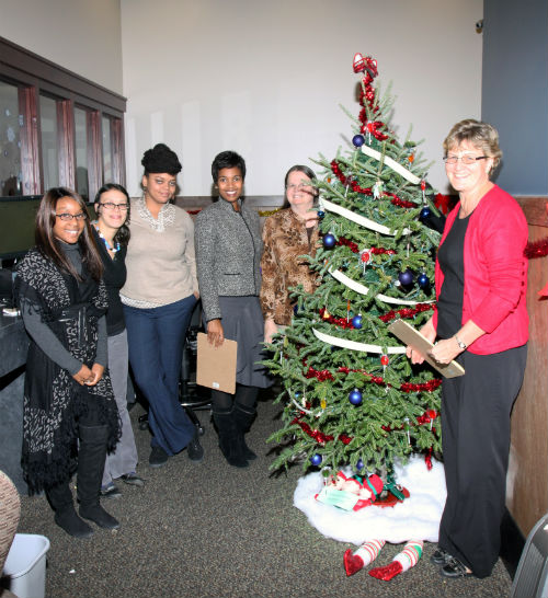 COR employees and contest judges pose by the Wizard of Oz entry in the 2012 Tree Decorating Contest. 